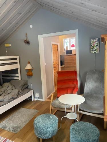 a bedroom with a bed and a table and chairs at Vintersemester Hundfjället Sälen in Sälen