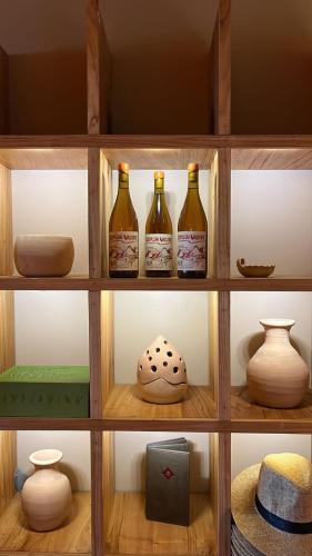a shelf with bottles and vases on it at Hotel Internacional in Mendoza