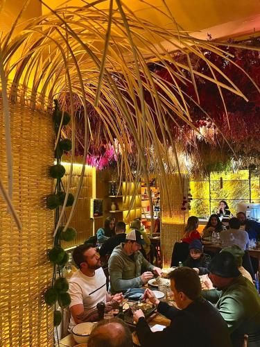 a group of people sitting at tables in a restaurant at Hotel Internacional in Mendoza