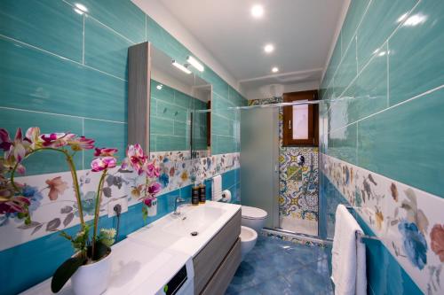 a blue bathroom with a toilet and a sink at Terrace Belvedere suite- Amalfi coast - free park- Pontone -Scala in Pontone