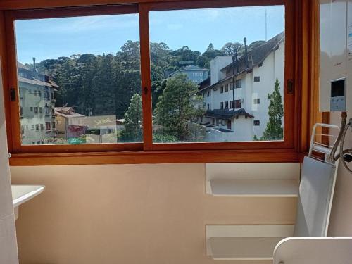 a window with a view of a city at Novo Aconchego in Gramado