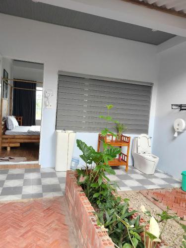 a bathroom with a toilet in a house at Khu nghỉ dưỡng sinh thái Apsara Sóc Trăng in Ấp Vĩnh Hưng