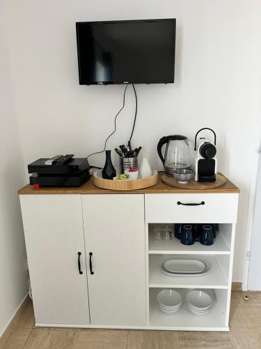 a white cabinet with a television on top of it at Maison familiale et chaleureuse à la chaume av 2 chambres, terrasse, wifi in Les Sables-dʼOlonne