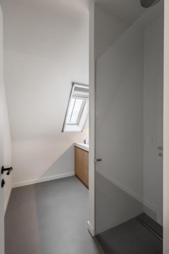 a room with white walls and a door with a window at Oase d'Itegem - Wellness & Luxe in Heist-op-den-Berg