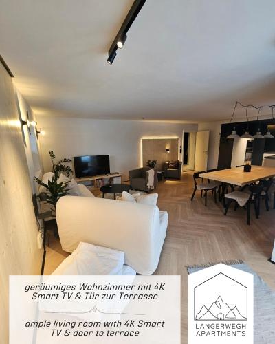 a living room with a couch and a table at Langerwegh Apartments AP2 in Fieberbrunn