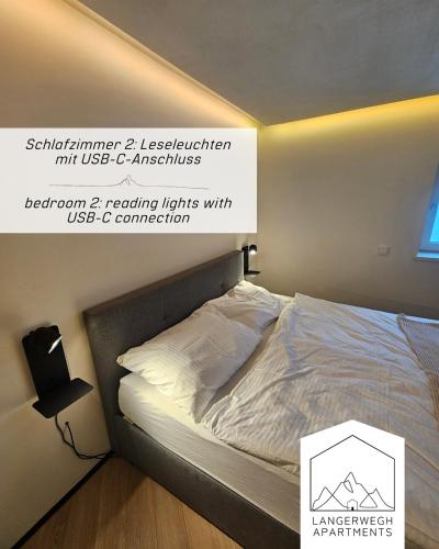 a bed in a bedroom with a sign on the wall at Langerwegh Apartments AP2 in Fieberbrunn