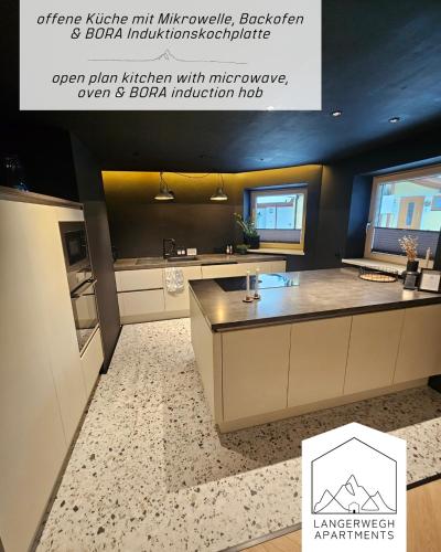 a kitchen with a large island in a room at Langerwegh Apartments AP2 in Fieberbrunn