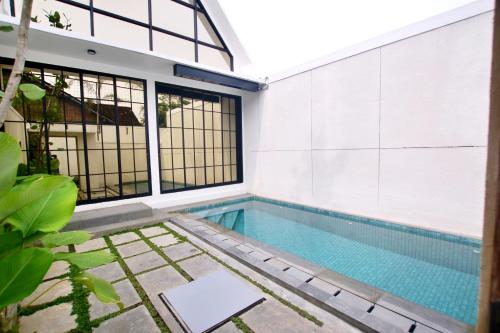 a swimming pool in the middle of a house at Gauri Vasanta Villa with Private Pool Yogyakarta in Yogyakarta