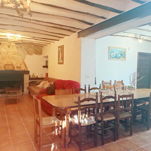 a living room with a table and chairs and a couch at San Antonio 4 vientos in Pétrola