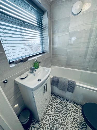 a bathroom with a sink and a tub and a toilet at Keekle Cottage - 2 Bedrooms - Sleeps 4 in Cleator Moor