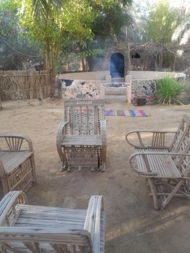 a group of benches and tables in a yard at أطيل إنشال Camp Atil Inshaal in `Ezbet Bûgti