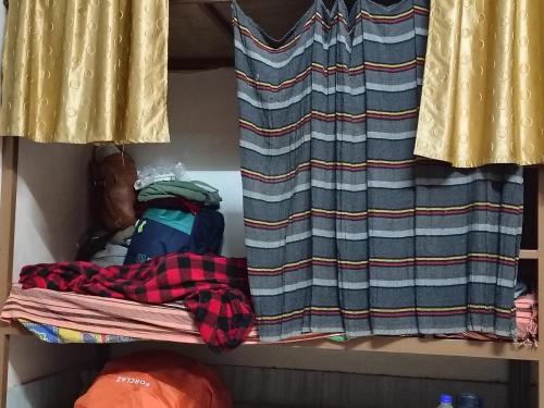 a closet with a curtain and a pile of clothes at SA HAVELi in Bikaner