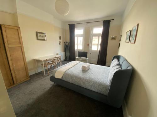 a bedroom with a bed and a table in it at The Florence Room in Norwood