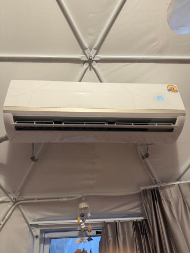 a white air conditioner hanging from a ceiling at Infinity Beach Club Resort & Hostel Koh Phangan in Baan Tai