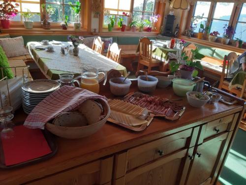 a table with food on top of a wooden table at Panoramapension Platzer in Kolbnitz