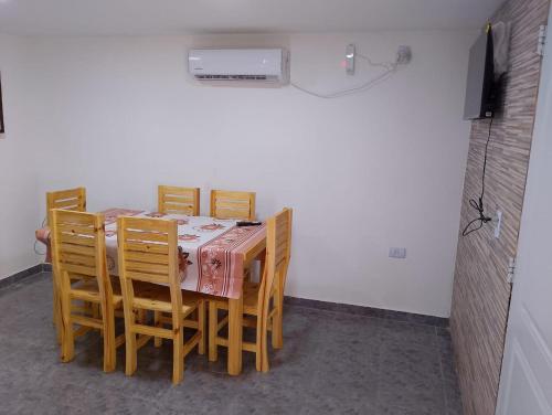 a dining room with a table and four chairs at La casita de bolson in El Bolsón