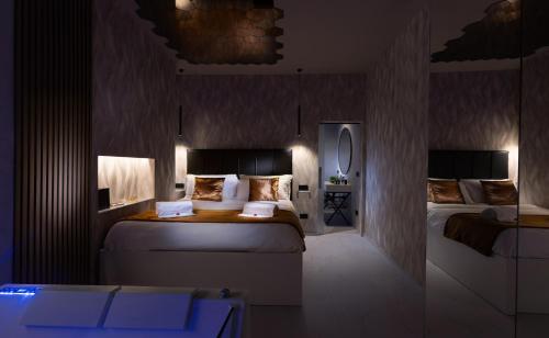 a hotel room with two beds and a mirror at CM Luxury Apartment in Catania
