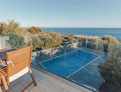 a swimming pool on the balcony of a house at Villa Neli II in Achlia