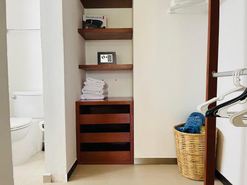 a bathroom with a wooden shelf and a toilet at Experience tranquility and comfort accommodation, near main attractions in Riviera Maya in Lafitte
