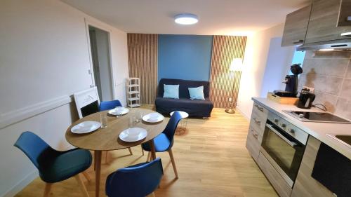 a kitchen and dining room with a table and chairs at La Petite Cuvée confort & elegance in Beaune