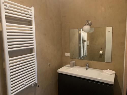 a bathroom with a sink and a mirror at casa morola Monolocale in Trani