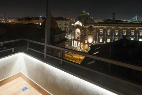 a view of a city at night from a balcony at Apartments Villa Savamala in Belgrade