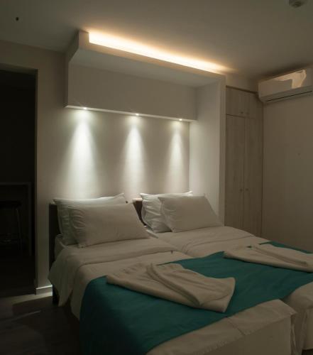 a bedroom with two beds with towels on them at Apartments Villa Savamala in Belgrade