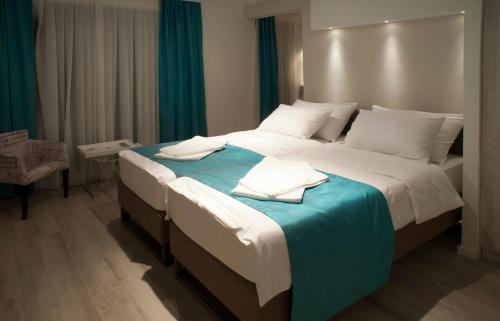 a bedroom with a large bed with a blue blanket at Apartments Villa Savamala in Belgrade