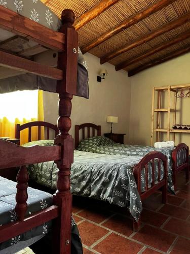 a bedroom with two bunk beds in a room at Hotel La Herencia in Tilcara