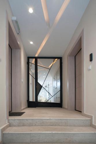a hallway with a glass door in a building at Apartments Villa Savamala in Belgrade