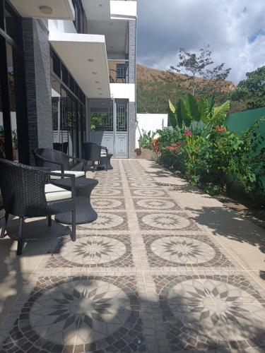 a patio with chairs and a tiled floor at Bella Villa Coron in Coron