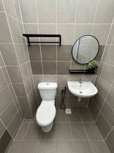 a bathroom with a toilet and a sink at Rumavin Homestay, Seremban in Seremban