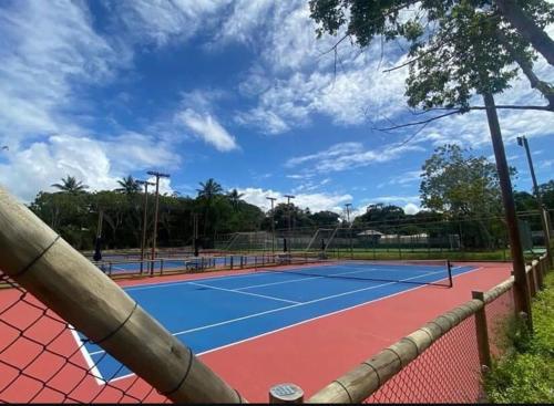a tennis court with two tennis courts at casa condomínio praia do castelo in Mata de Sao Joao
