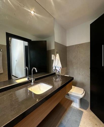 a bathroom with a sink and a toilet at casa condomínio praia do castelo in Mata de Sao Joao