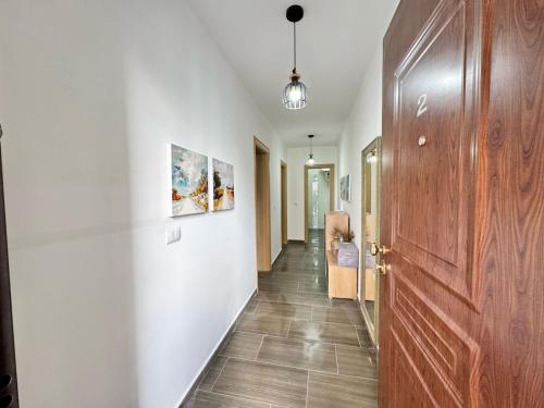 a hallway with a wooden door and a hallway with a hallway at Wiola's Vlora Private Villa with private parking in Vlorë
