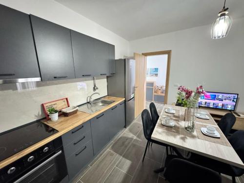 a kitchen with a table with chairs and a counter top at Wiola's Vlora Private Villa with private parking in Vlorë