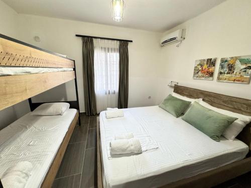 a bedroom with two bunk beds and a window at Wiola's Vlora Private Villa with private parking in Vlorë