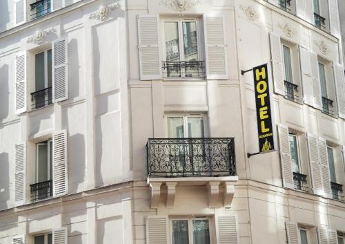 a building with a balcony and a sign on it at Hotel Audran in Paris