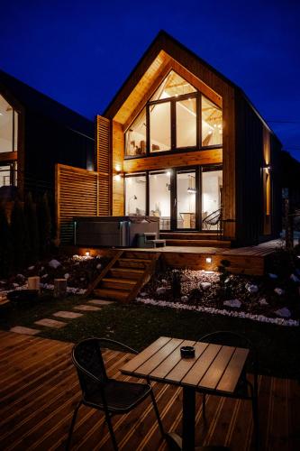 a house with a table in the yard at night at Golden Wood in Sovata