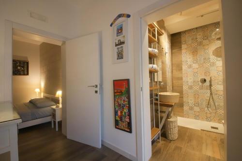 a small room with a bed and a bathroom at Nilu al Mare - Villa pool & sea Monopoli in Monopoli