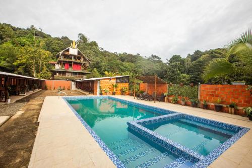 a swimming pool in the middle of a house at Playa Lodge in El Valle