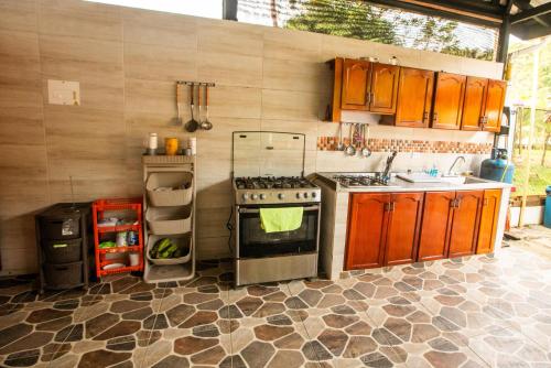 a kitchen with a stove and a sink at Playa Lodge in El Valle