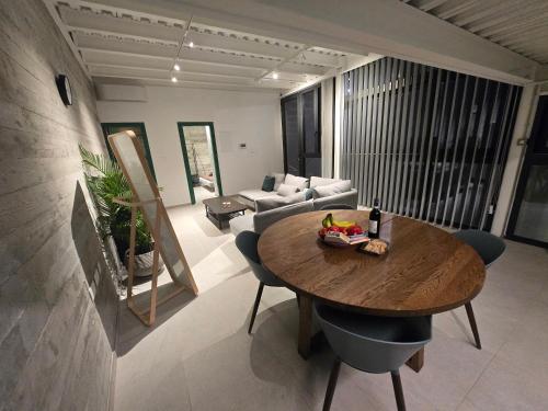 a living room with a table and a couch at Green Leaf - Old City Suite in Limassol