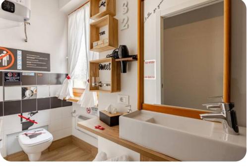 a bathroom with a sink and a toilet at Portico 32 - Merano centro in Merano