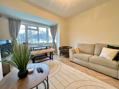 a living room with a couch and a table at Lovely spacious 3 double bed flat, LS17 in Leeds