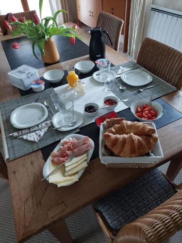 a wooden table with food on top of it at Aux Trois Mûriers in Villeneuve-sur-Lot