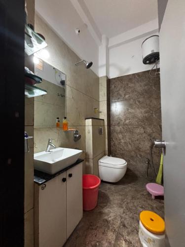 a bathroom with a sink and a toilet at Swastik Home stay in Ujjain