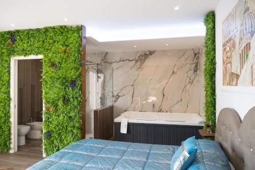 a bedroom with a green wall with a bath tub at Etna Exclusive in Ragalna