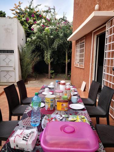 a table with food and drinks on a patio at Belle villa in Poponguine