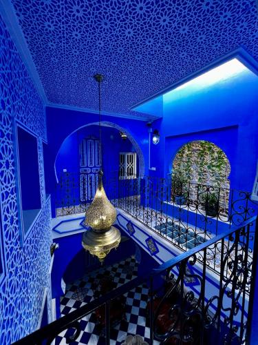a blue room with a blue ceiling and a lamp at RIAD CHENGLI 蓝城里 in Chefchaouene